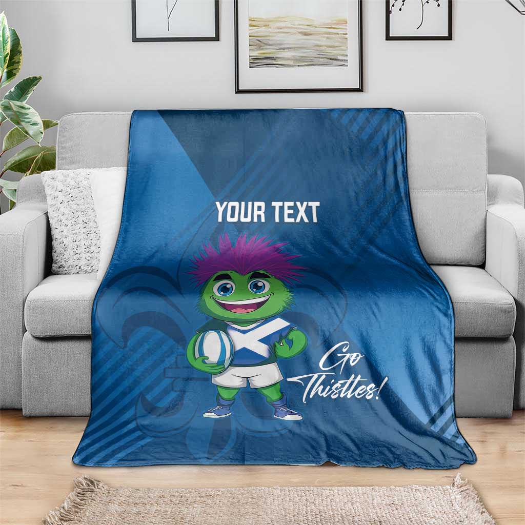 Blue rugby mascot blanket on sofa, 'Your Text' and 'Go Thistles!' design