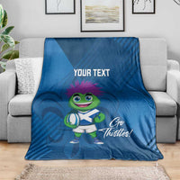 Blue rugby mascot blanket on sofa, 'Your Text' and 'Go Thistles!' design