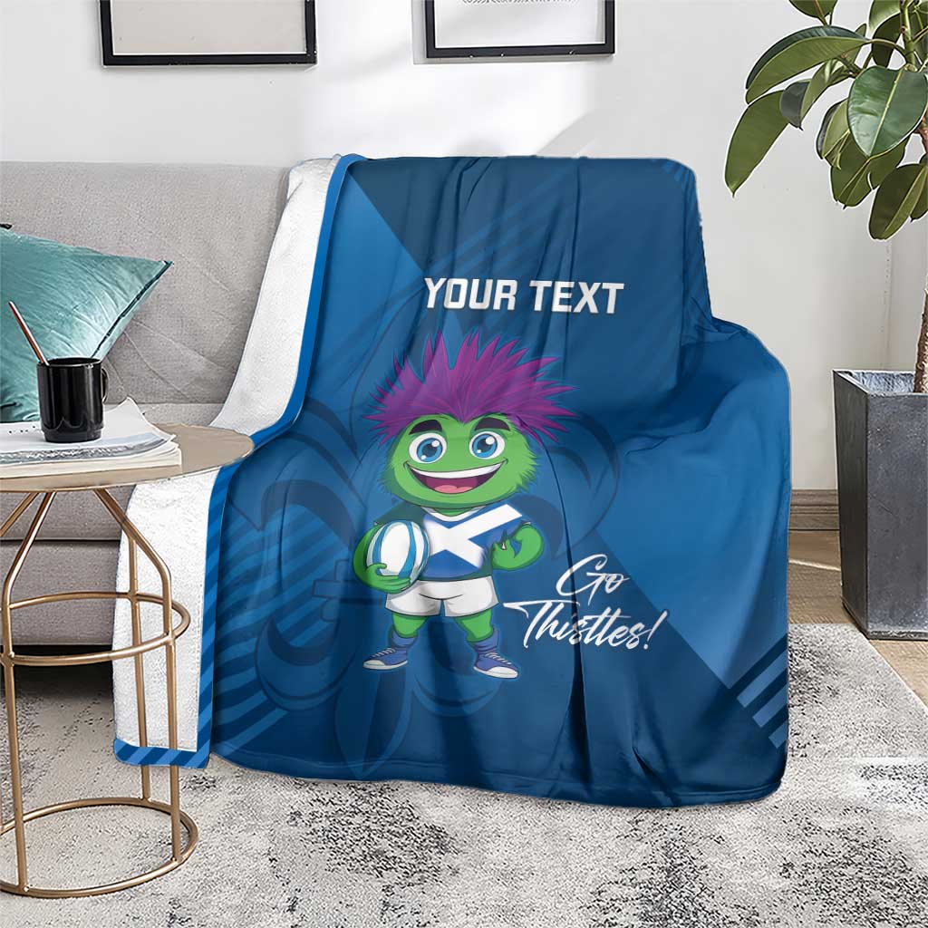 Blue rugby mascot blanket on floor, 'Your Text' and 'Go Thistles!' artwork