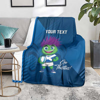 Blue rugby mascot blanket on floor, 'Your Text' and 'Go Thistles!' artwork