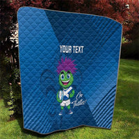 Blue quilt blanket with 'YOUR TEXT' and green thistle mascot, outdoor yard view