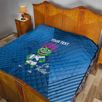 Blue quilt blanket on bed with 'YOUR TEXT' and green thistle mascot print