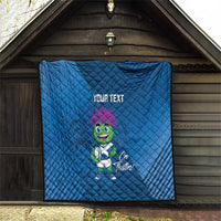 Blue quilt blanket displayed indoors with 'YOUR TEXT' and green thistle mascot