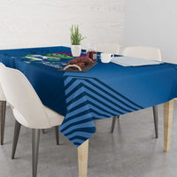 Blue tablecloth draped on dining table with thistle mascot and stripe design