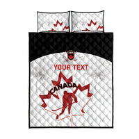 White quilt with red maple leaf and red 'YOUR TEXT', with matching pillows and black edge.
