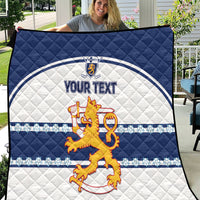 Blue and white quilt with quilted pattern, lion crest, and “YOUR TEXT” center