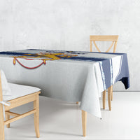 Custom hockey tablecloth draped on dining table with dark blue border stripe and emblem