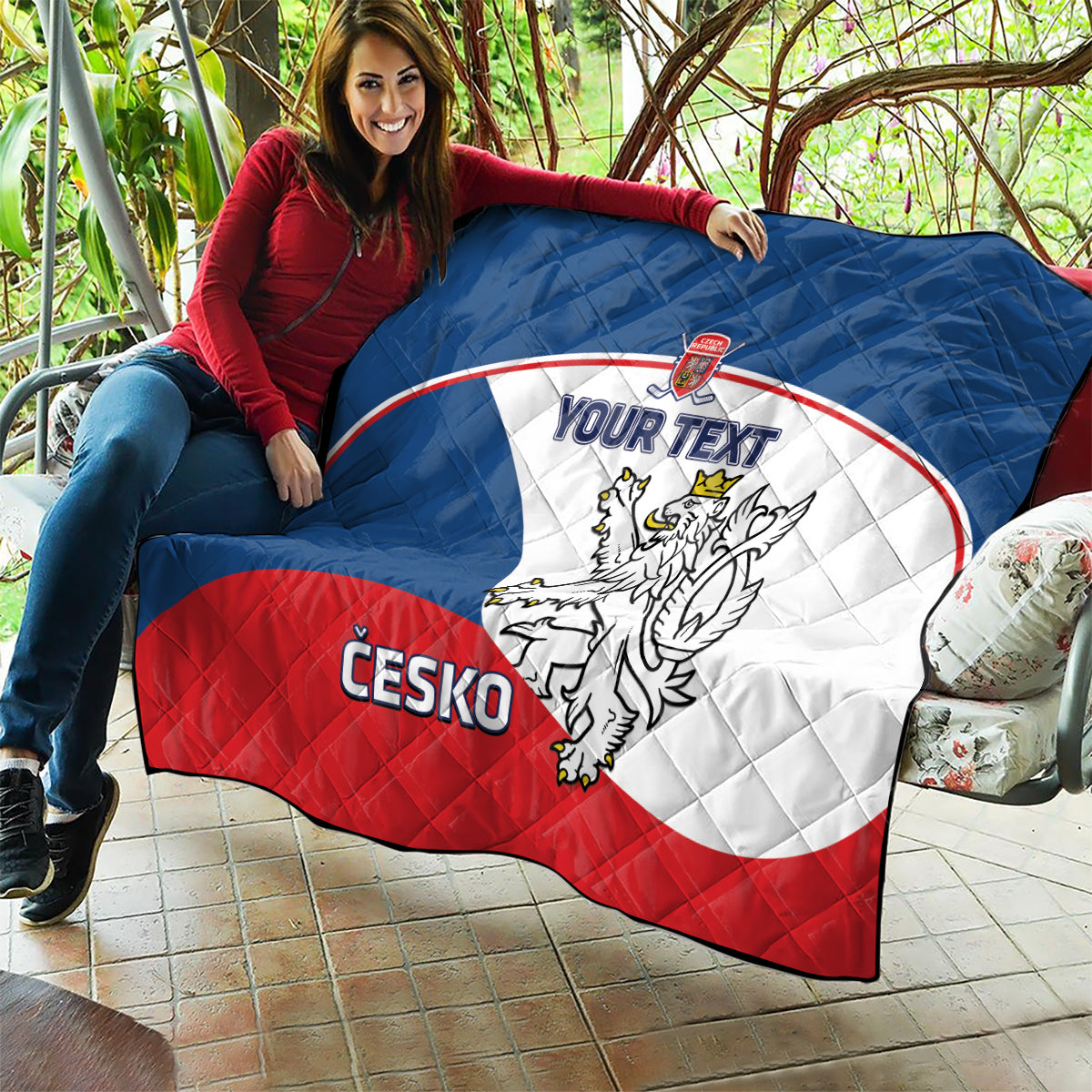 Custom Czech hockey quilt held outside in blue, white, and red with crest and “YOUR TEXT”.