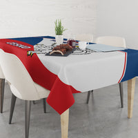 Red, blue, and white Czech hockey tablecloth on a dining table with decor