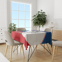 Red, blue, and white hockey tablecloth on dining table with chairs