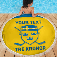 Yellow round beach blanket with fringe, Sweden crest and 'TRE KRONOR' near pool