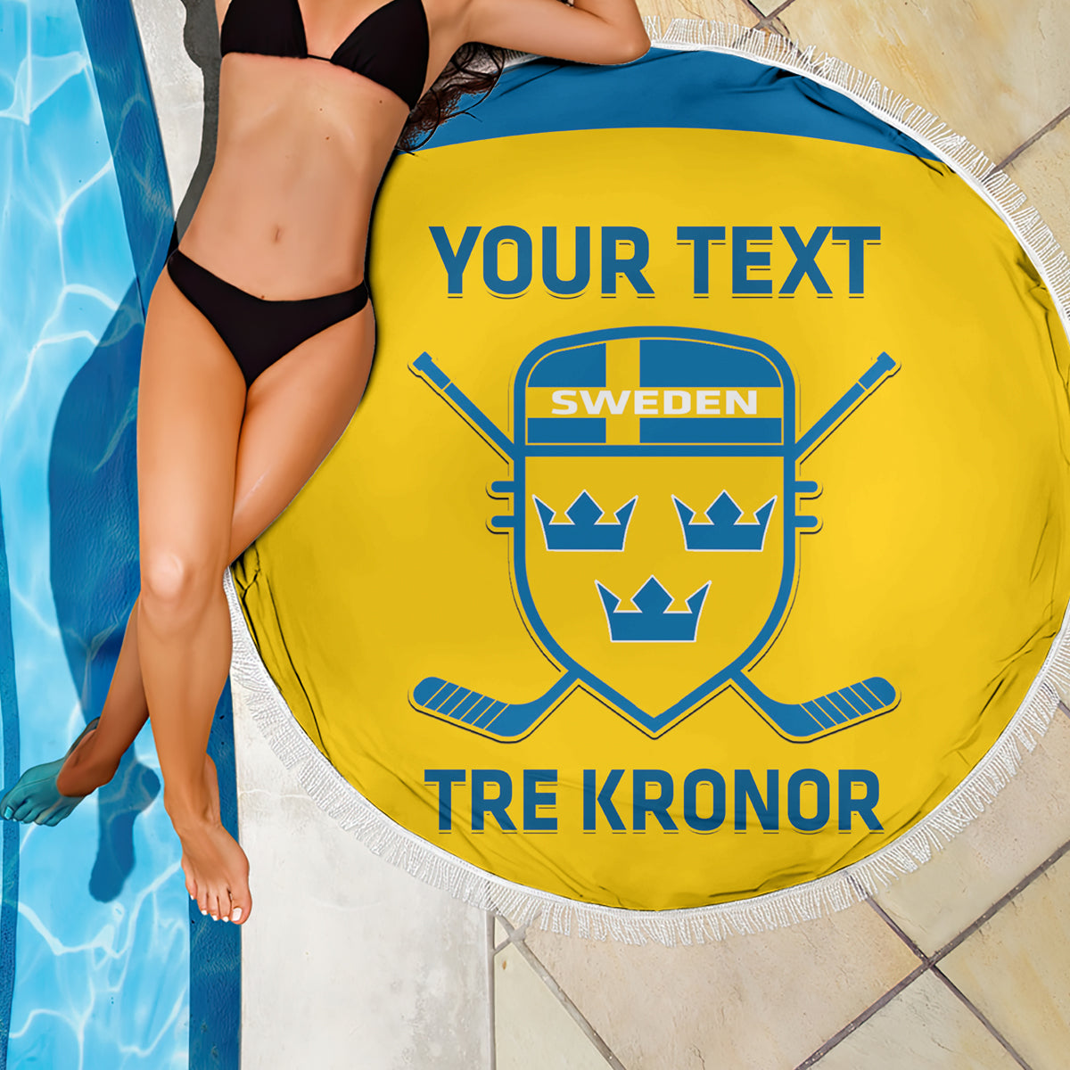 Yellow round beach blanket with fringe, Sweden crest and 'YOUR TEXT' over poolside