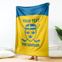 Sweden hockey blanket hanging, yellow with blue top band, crest and “TRE KRONOR”