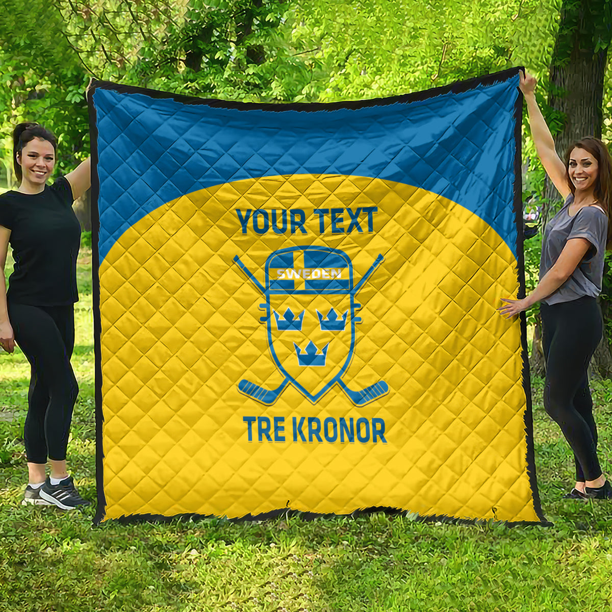 Custom Sweden hockey quilt laid out outdoors, blue border and yellow center with crest