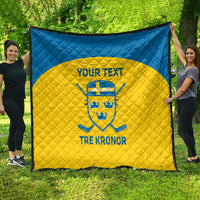 Custom Sweden hockey quilt laid out outdoors, blue border and yellow center with crest