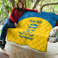 Custom Sweden hockey quilt held up outdoors, blue border and yellow center with Sweden crest