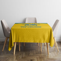 Yellow square tablecloth with blue logo stripe, draped over table and chairs