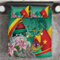 Green bedding set with Cameroon flag design, lion crest, monument tower and pink lilies