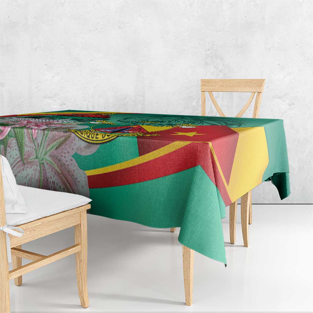 Corner of green and multicolor tablecloth with pink flower accents and draped edge