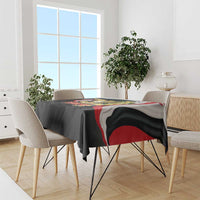 Black tablecloth with Yemen emblem and flag-style red-white stripe across tabletop
