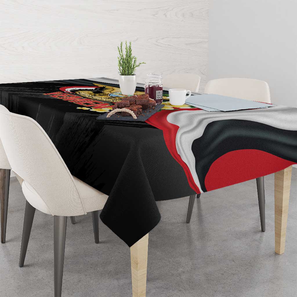 Black Yemen tablecloth draped over dining table, featuring red-white stripe and emblem