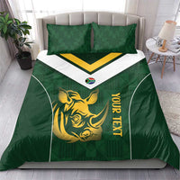 Green duvet cover and pillow shams with gold rhino emblem, yellow wordmark, white chevron