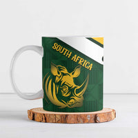 Green ceramic mug with gold rhino and “SOUTH AFRICA” text