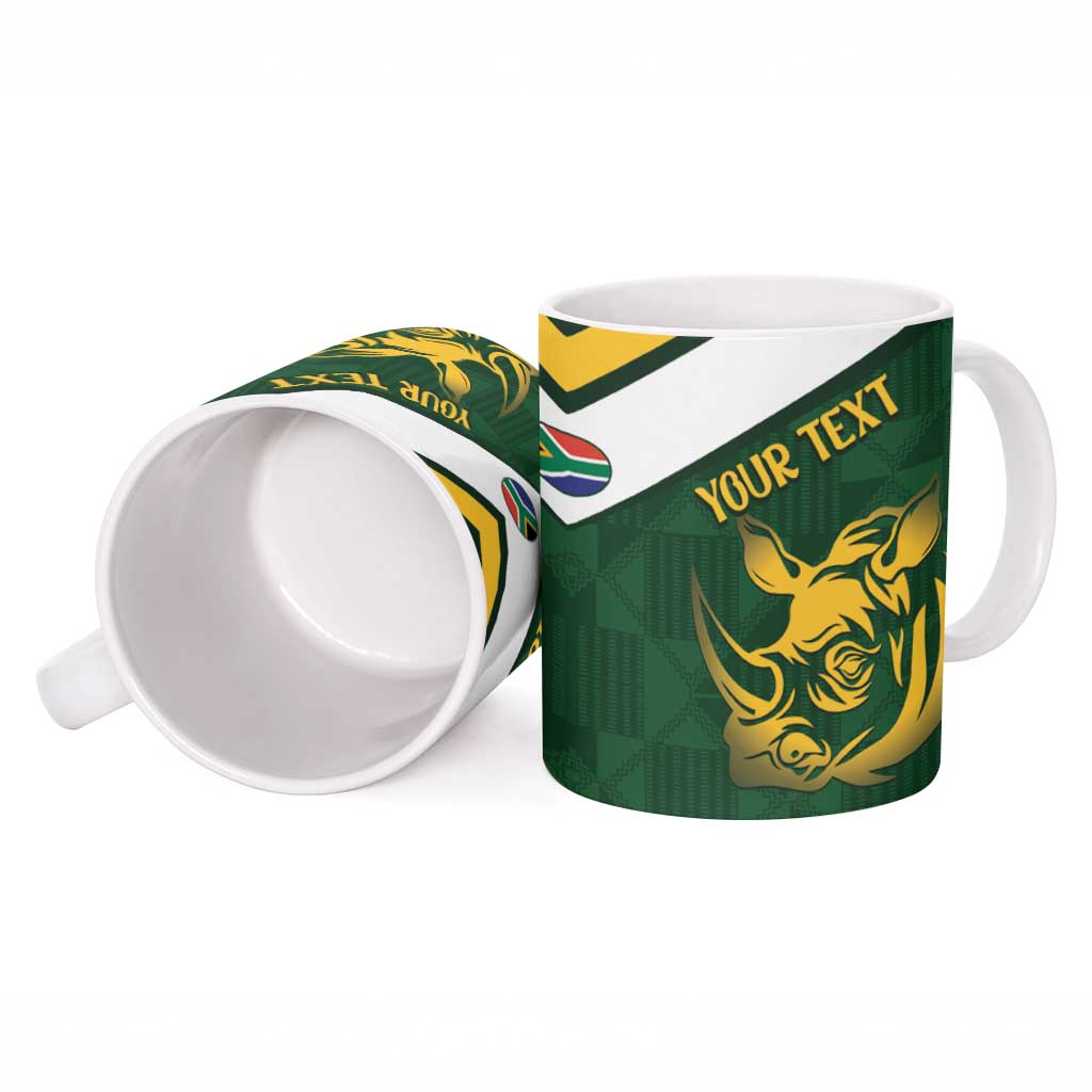 Green ceramic mug, open view, with gold rhino and “YOUR TEXT” on front