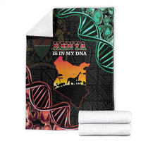Folded black Kenya map blanket with 'KENYA IS IN MY DNA' text and green-red graphic accents.
