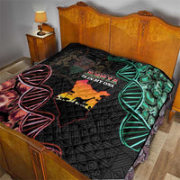 Black quilt blanket on bed with Kenya map, green DNA helix, and red patterned lines