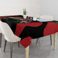 Safari themed tablecloth with black base and red patterned sides, green and animal emblem at center