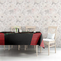 Safari themed tablecloth on dining table, red and black design with green strip and animal emblem