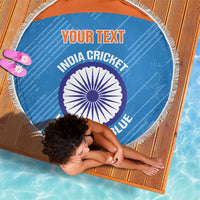 Blue round beach blanket with white tassel fringe and India cricket logo text