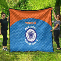 Full view blue quilt with orange top border, quilted pattern, India cricket women logo