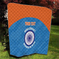 Folded blue quilt with orange edge and India cricket women in blue circular emblem
