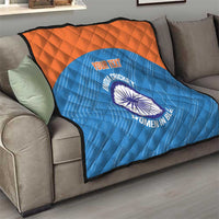 Blue quilt with orange top stripe on sofa, quilted design and India cricket women logo