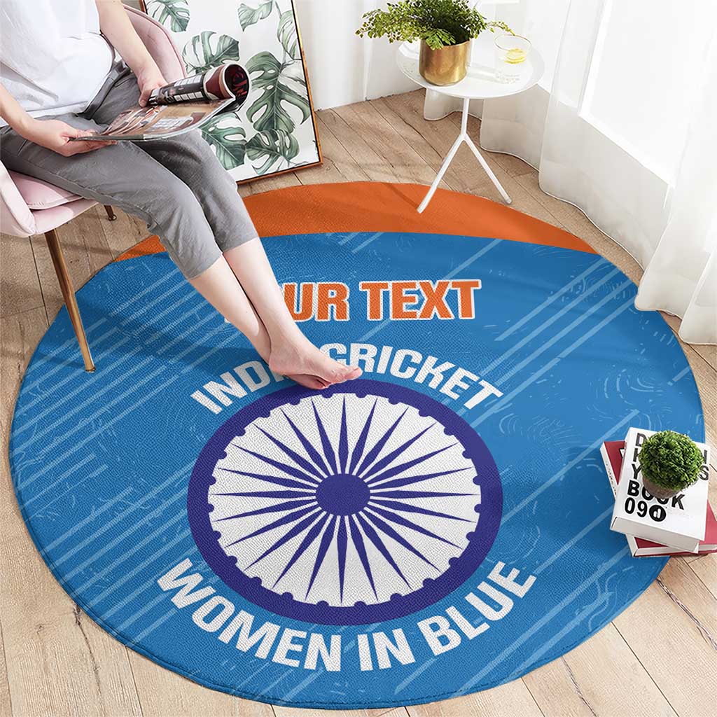 Blue round carpet with orange border and printed cricket text, central emblem