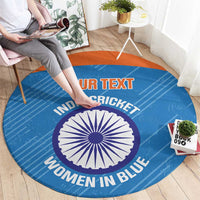 Blue round carpet with orange border and printed cricket text, central emblem