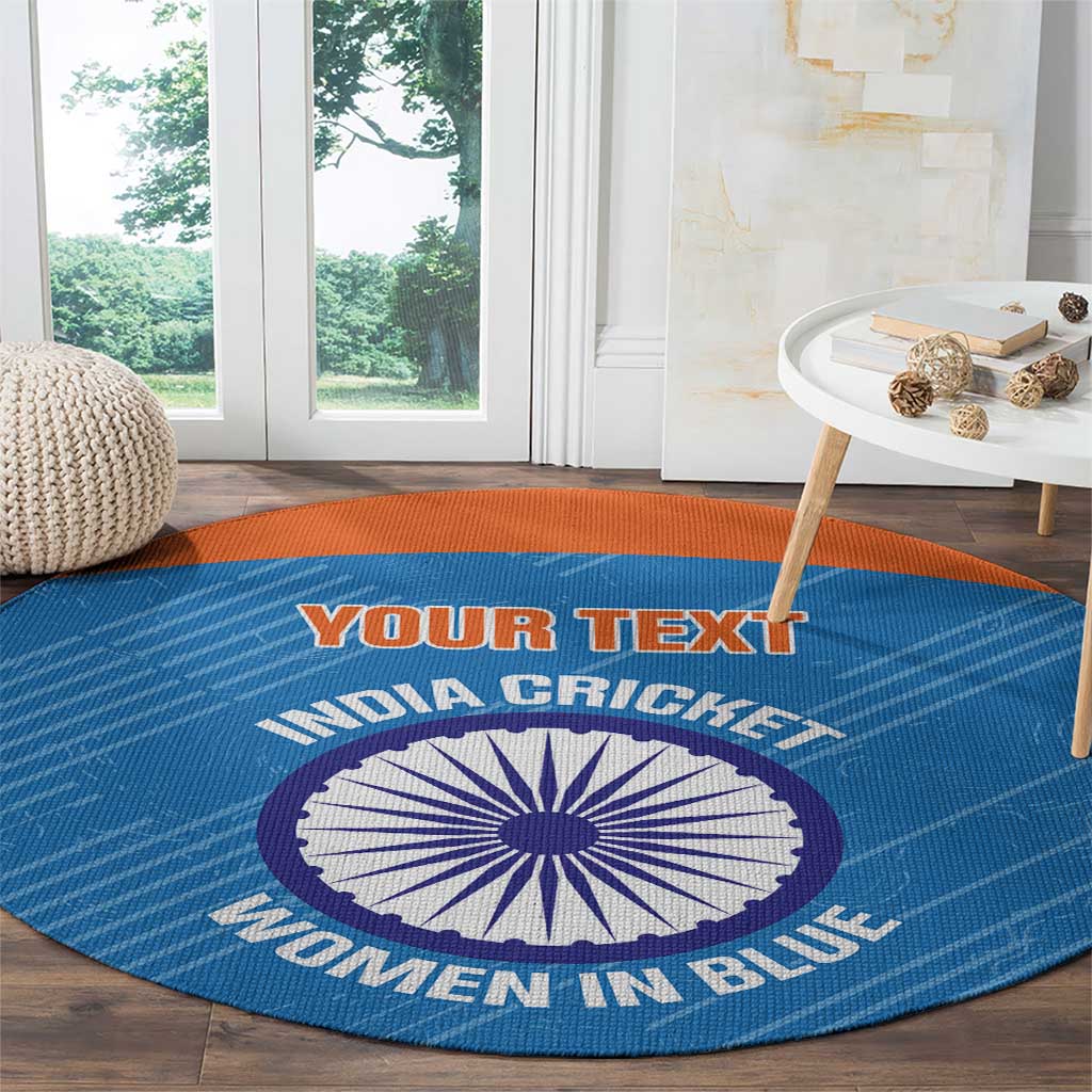 Blue round carpet with orange border, cricket emblem and arced printed text