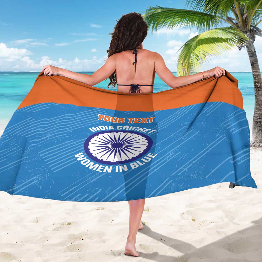 Blue women’s sarong with orange border and printed “YOUR TEXT” cricket emblem