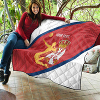 Large Serbia flag quilt draped outdoors with red field, blue diagonal stripe and crest
