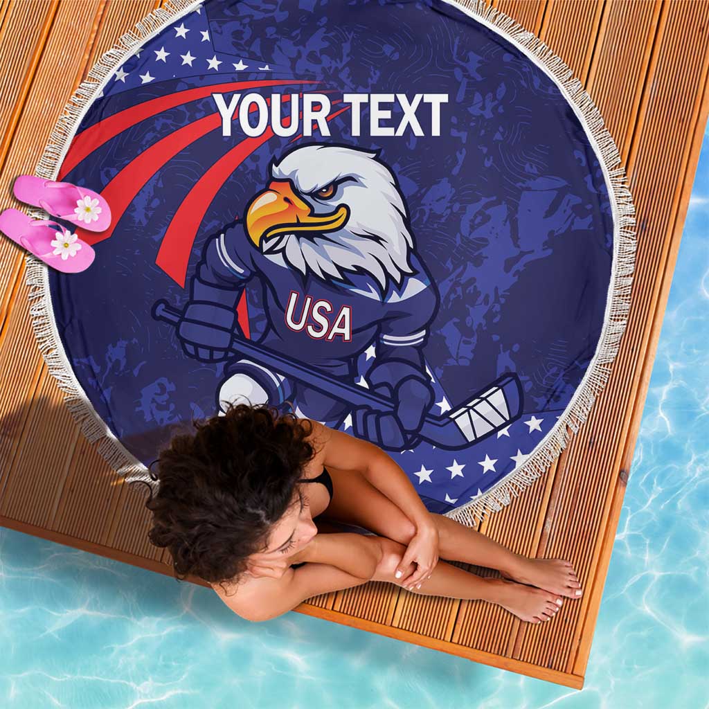 Blue round beach blanket with eagle hockey mascot and USA graphic, white fringe border