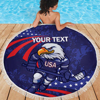 Blue round beach blanket with eagle hockey mascot, USA graphic and white fringe border