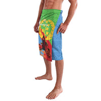 Green blue red Eritrea-themed lavalava shorts with laurel graphic, side view on model