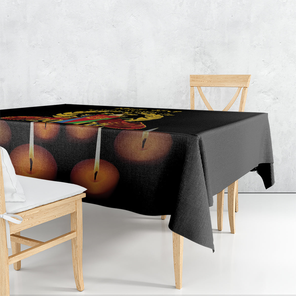 Black tablecloth with printed candle design draped over a dining table