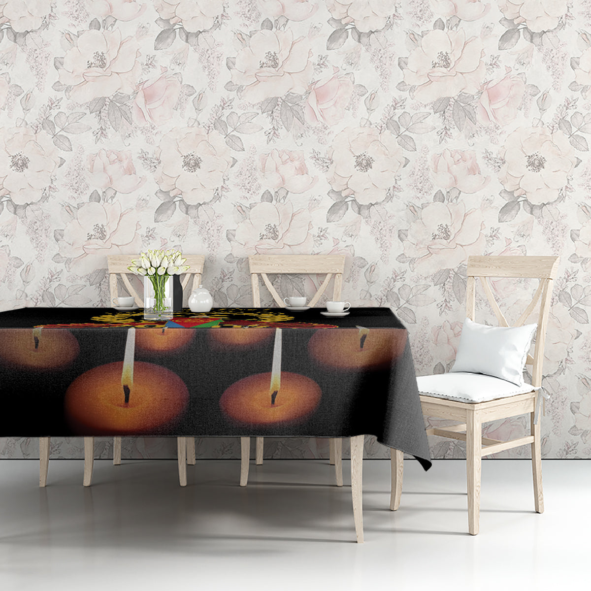 Black tablecloth with printed candles on tabletop at seated dining chairs
