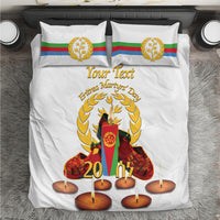 White duvet cover and pillowcases with gold wreath, candles, and flag emblem