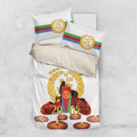 White duvet with candle design and gold wreath; matching flag-striped pillowcases