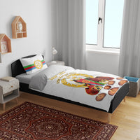 White bedding set with printed pillows, candles, wreath, and flag-themed design