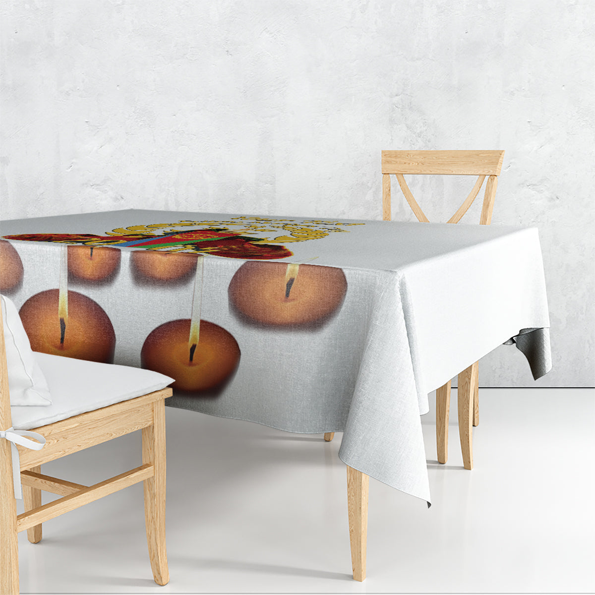 White tablecloth with candle-flame print, draped over table corner